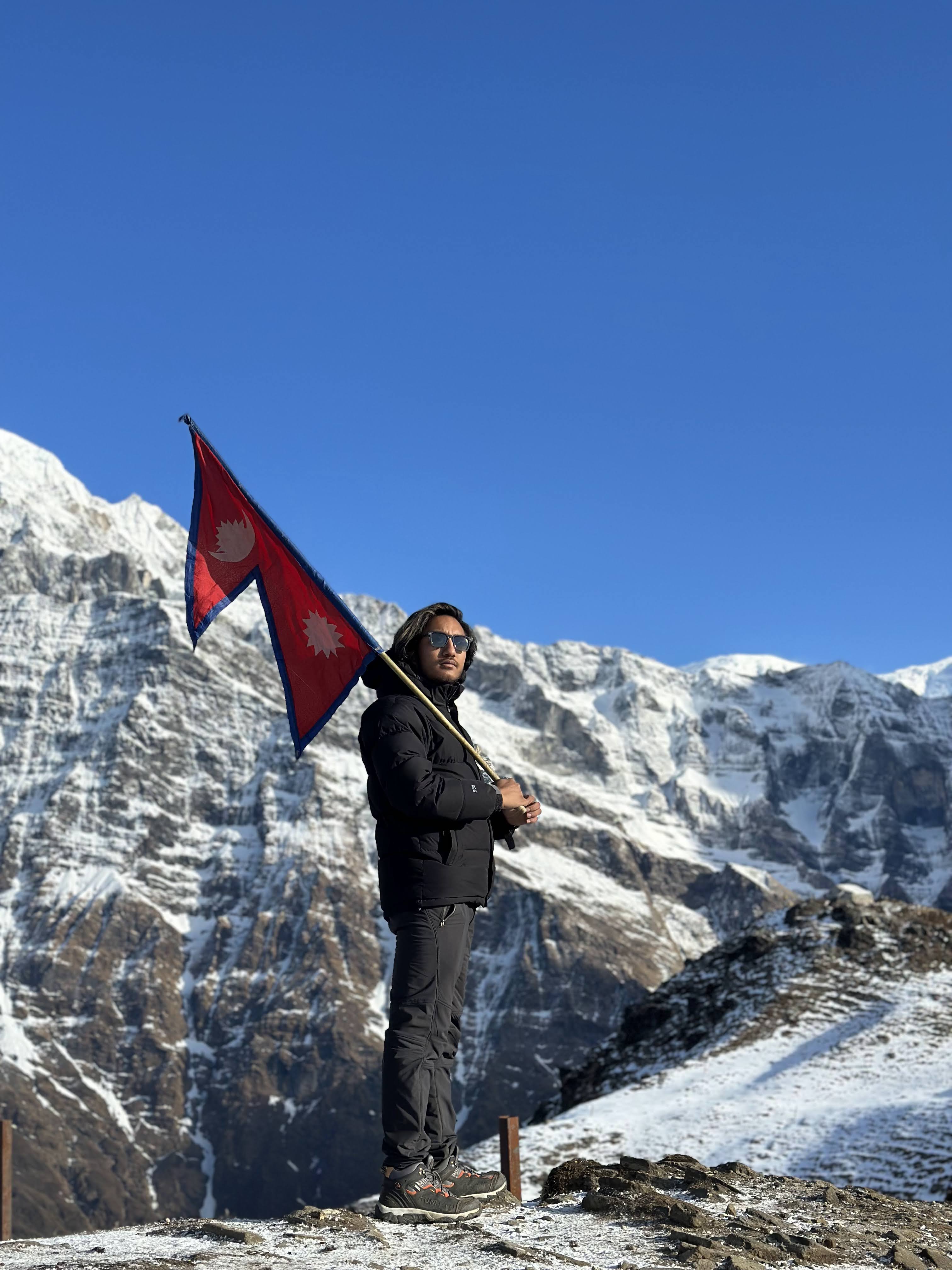 Rikesh shrestha at mardi with the Nepal's flag